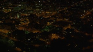 4K aerial stock footage flying by Hotel Captain Cook, tilt up to reveal Downtown Anchorage, Alaska, night Aerial Stock Footage | AK0001_0208