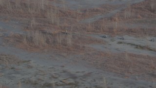 AK0001_0214 - 4K aerial stock footage approaching four-wheelers riding through the valley, Knik River Valley, Alaska