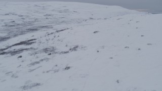 4K aerial stock footage flying low over snow covered slopes, Chugach Mountains, Alaska Aerial Stock Footage | AK0001_0235