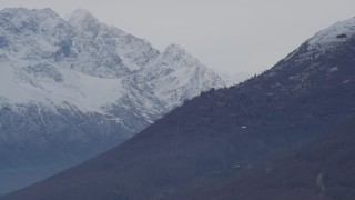 4K aerial stock footage flying along a slope, eclipsing snow covered peaks, Chugach Mountains, Alaska Aerial Stock Footage | AK0001_0237