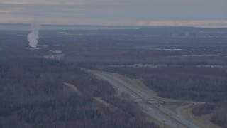 4K aerial stock footage pan right by Glenn Highway, plower plant, Anchorage, Alaska Aerial Stock Footage | AK0001_0239