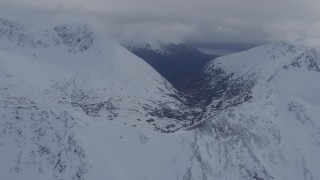 4K aerial stock footage flying along snowy range, valley in the distance, Chugach Mountains, Alaska Aerial Stock Footage | AK0001_0260