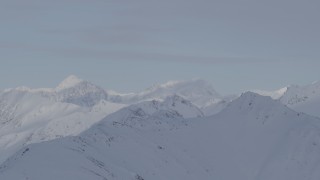 4K aerial stock footage flying by heavily snow covered mountain peaks, Chugach Mountains, Alaska Aerial Stock Footage | AK0001_0269