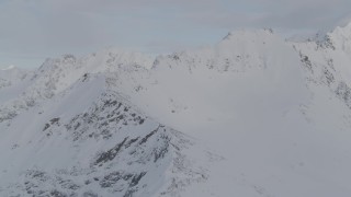 4K aerial stock footage flying along a snowy ridge, approaching a summit, Chugach Mountains, Alaska Aerial Stock Footage | AK0001_0272