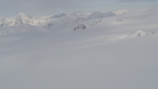 4K aerial stock footage pan left across snow covered valley, peaks, Chugach Mountains, Alaska Aerial Stock Footage | AK0001_0273