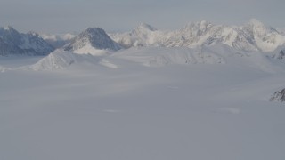 4K aerial stock footage approaching snowy peaks, across a snowy valley, Chugach Mountains, Alaska Aerial Stock Footage | AK0001_0274