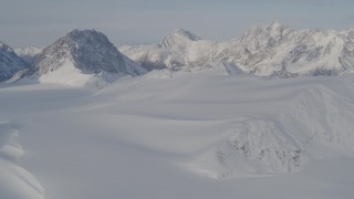 4K aerial stock footage fly over snowy valley, pan across the mountain peaks, Chugach Mountains, Alaska Aerial Stock Footage | AK0001_0275