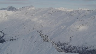 4K aerial stock footage tilt down on summit, revealing a deep valley, Chugach Mountains, Alaska Aerial Stock Footage | AK0001_0276