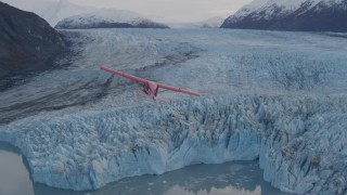 AK0001_0284 - 4K aerial stock footage tracking seaplane over a glacier, lake, Inner Lake George, Alaska