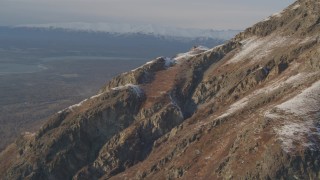 4K aerial stock footage ascend rocky slope of lightly snow covered peak, Chugach Mountains, Alaska Aerial Stock Footage | AK0001_0293