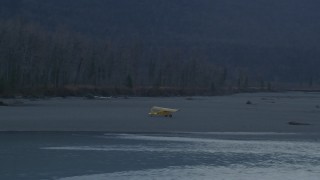 4K aerial stock footage orbiting a small plane parked on shore of the river, Knik River, Alaska, twilight Aerial Stock Footage | AK0001_0309