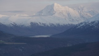 4K aerial stock footage flying by snow capped mountain peak, Chugach Mountains, Alaska, twilight Aerial Stock Footage | AK0001_0318