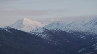 4K aerial stock footage flying by snowy mountain peaks, Chugach Mountains, Alaska, twilight Aerial Stock Footage | AK0001_0320