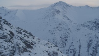 4K aerial stock footage approaching snow covered ridge and peak, Chugach Mountains, Alaska, twilight Aerial Stock Footage | AK0001_0324