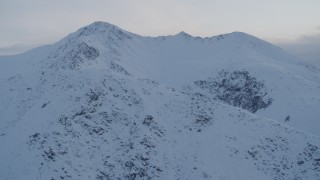 4K aerial stock footage fly over snowy ridge, approach snowy peak, Chugach Mountains, Alaska, twilight Aerial Stock Footage | AK0001_0325