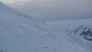 4K aerial stock footage approaching snow covered slope, Chugach Mountains, Alaska, twilight Aerial Stock Footage | AK0001_0326