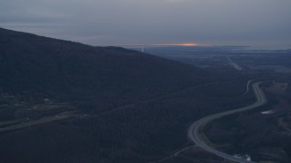 4K aerial stock footage following Glenn Highway, approaching Anchorage, Eagle River, Alaska, twilight Aerial Stock Footage | AK0001_0331