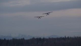 4K aerial stock footage two planes approaching camera, veering left, Anchorage, Alaska, twilight Aerial Stock Footage | AK0001_0335