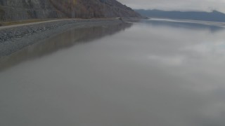 AK0001_0366 - 4K aerial stock footage flying by shore, reveal Seward Highway, Turnagain Arm of the Cook Inlet, Alaska