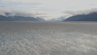 AK0001_0370 - 4K aerial stock footage flying low over the water, tilt down, Turnagain Arm of the Cook Inlet, Alaska