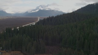 AK0001_0379 - 4K aerial stock footage approaching wooded foothills, Kenai Mountains, Alaska