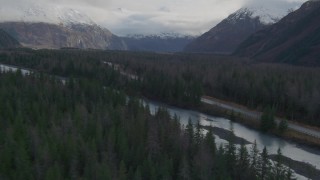 4K aerial stock footage flying low over forest, revealing river, Portage Glacier Road, Portage Lake, Alaska Aerial Stock Footage | AK0001_0388