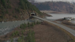 AK0001_0390 - 4K aerial stock footage follow Portage Glacier Highway approach mountain tunnel, Portage Lake, Alaska