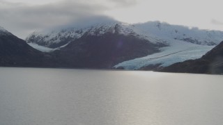 AK0001_0392 - 4K aerial stock footage flying over lake, pan right to reveal Portage Glacier, Portage Lake, Alaska