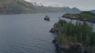 4K aerial stock footage flying by forested shoreline, small island, open waters, Passage Canal, Alaska Aerial Stock Footage | AK0001_0402