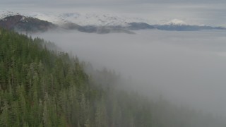 4K aerial stock footage fog covered bay, approaching Chugach Mountains, Prince William Sound, Alaska Aerial Stock Footage | AK0001_0413