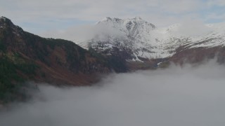 4K aerial stock footage fly around rim of Chugach Mountain ridge, fog, Prince William Sound, Alaska Aerial Stock Footage | AK0001_0415