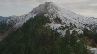 4K aerial stock footage ascend tree lined slope of Chugach Mountain ridge, Prince William Sound, Alaska Aerial Stock Footage | AK0001_0419