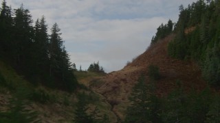 4K aerial stock footage over tree lined ridge, river valley, snowy peaks, Prince William Sound, Alaska Aerial Stock Footage | AK0001_0423