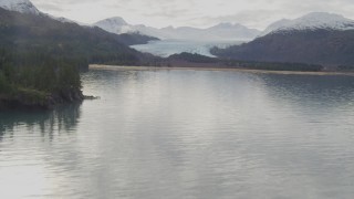 4K aerial stock footage flying low over water, approach marshy shore, glacier, Prince William Sound, Alaska Aerial Stock Footage | AK0001_0433