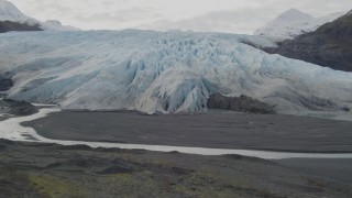 AK0001_0436 - 4K aerial stock footage tilt from shallow creek to reveal glacier, Prince William Sound, Alaska