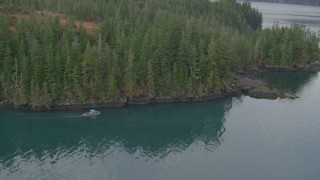 4K aerial stock footage fly by boat cruising the shoreline, out over the bay, Prince William Sound, Alaska Aerial Stock Footage | AK0001_0458