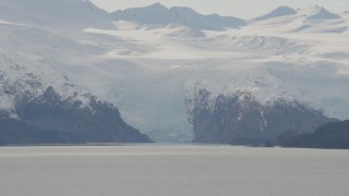 4K aerial stock footage flying by glacier cascading down rocky slopes into bay, Blackstone Bay, Alaska Aerial Stock Footage | AK0001_0462