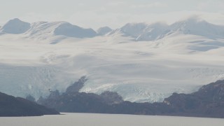 AK0001_0463 - 4K aerial stock footage a glacier spilling down from mountains to shore, Blackstone Bay, Alaska