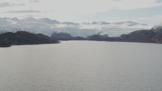 4K aerial stock footage glacier spilling down mountains, island in the bay, Blackstone Bay, Alaska Aerial Stock Footage | AK0001_0467