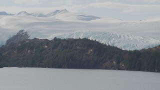 4K aerial stock footage flying by an island in the bay, glacier behind it, Blackstone Bay, Alaska Aerial Stock Footage | AK0001_0469