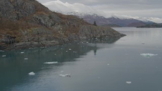 AK0001_0476 - 4K aerial stock footage fly along rocky, tree lined shore, Chugach Mountains, Blackstone Bay, Alaska