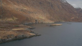 AK0001_0485 - 4K aerial stock footage small waterfalls pouring down face of slopes along shore, Blackstone Bay, Alaska