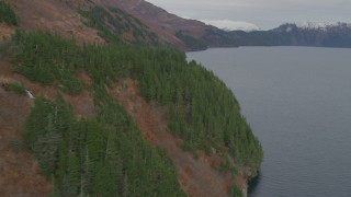 AK0001_0488 - 4K aerial stock footage flying along steep slope of mountain peak on the shore, Blackstone Bay, Alaska