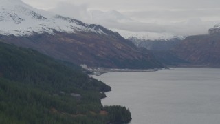 AK0001_0496 - 4K aerial stock footage flying along wooded shoreline, approaching Whittier, Alaska