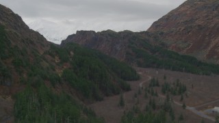 4K aerial stock footage flying beside country road, shallow creek, reveal pond and canyon, Whittier, Alaska Aerial Stock Footage | AK0001_0502