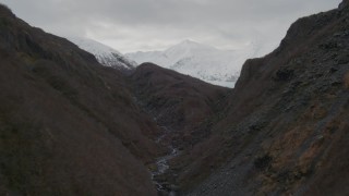 AK0001_0503 - 4K aerial stock footage flying through a shallow canyon, revealing Portage Glacier, Alaska