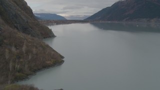 4K aerial stock footage flying along rocky slope, approach building, Portage Lake, Alaska Aerial Stock Footage | AK0001_0506