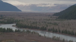 4K aerial stock footage flying by the river valley, tilt down to the river, Portage, Alaska Aerial Stock Footage | AK0001_0509