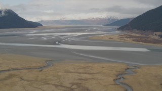 4K aerial stock footage flying by valley on the edge of Turnagain Arm of the Cook Inlet, Portage, Alaska Aerial Stock Footage | AK0001_0520