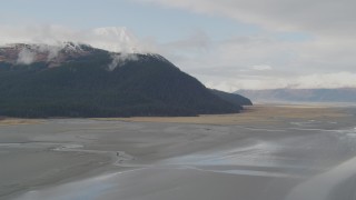 4K aerial stock footage approaching a snowy peak bordering a valley, Kenai Mountains, Alaska Aerial Stock Footage | AK0001_0522